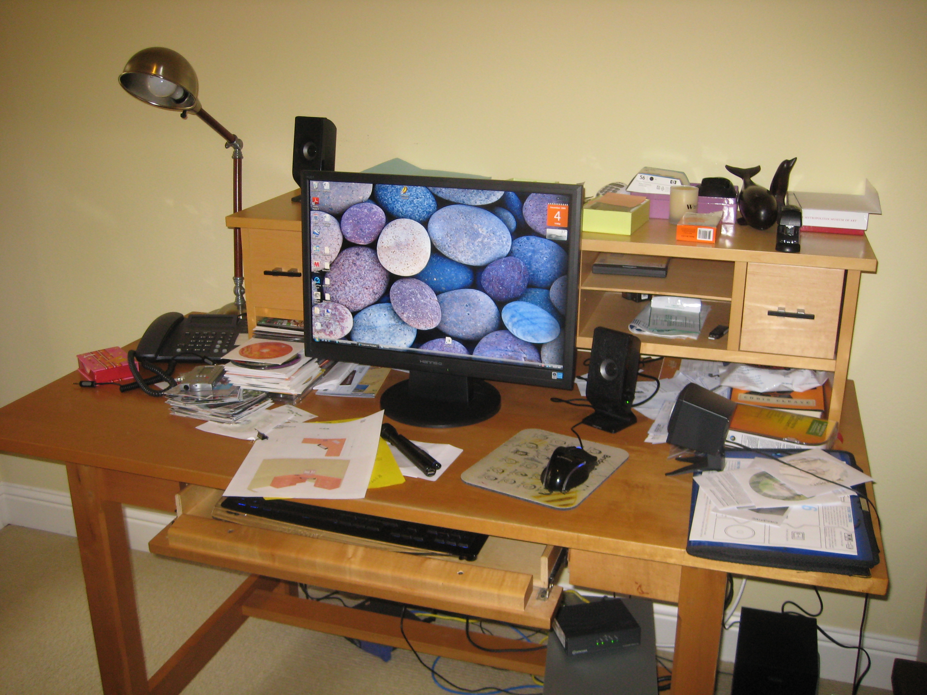 Cluttered office desk with no storage